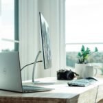 silver laptop on white table